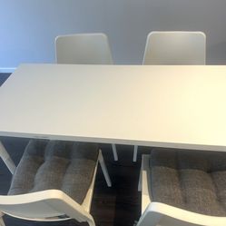 Table that includes four chairs.