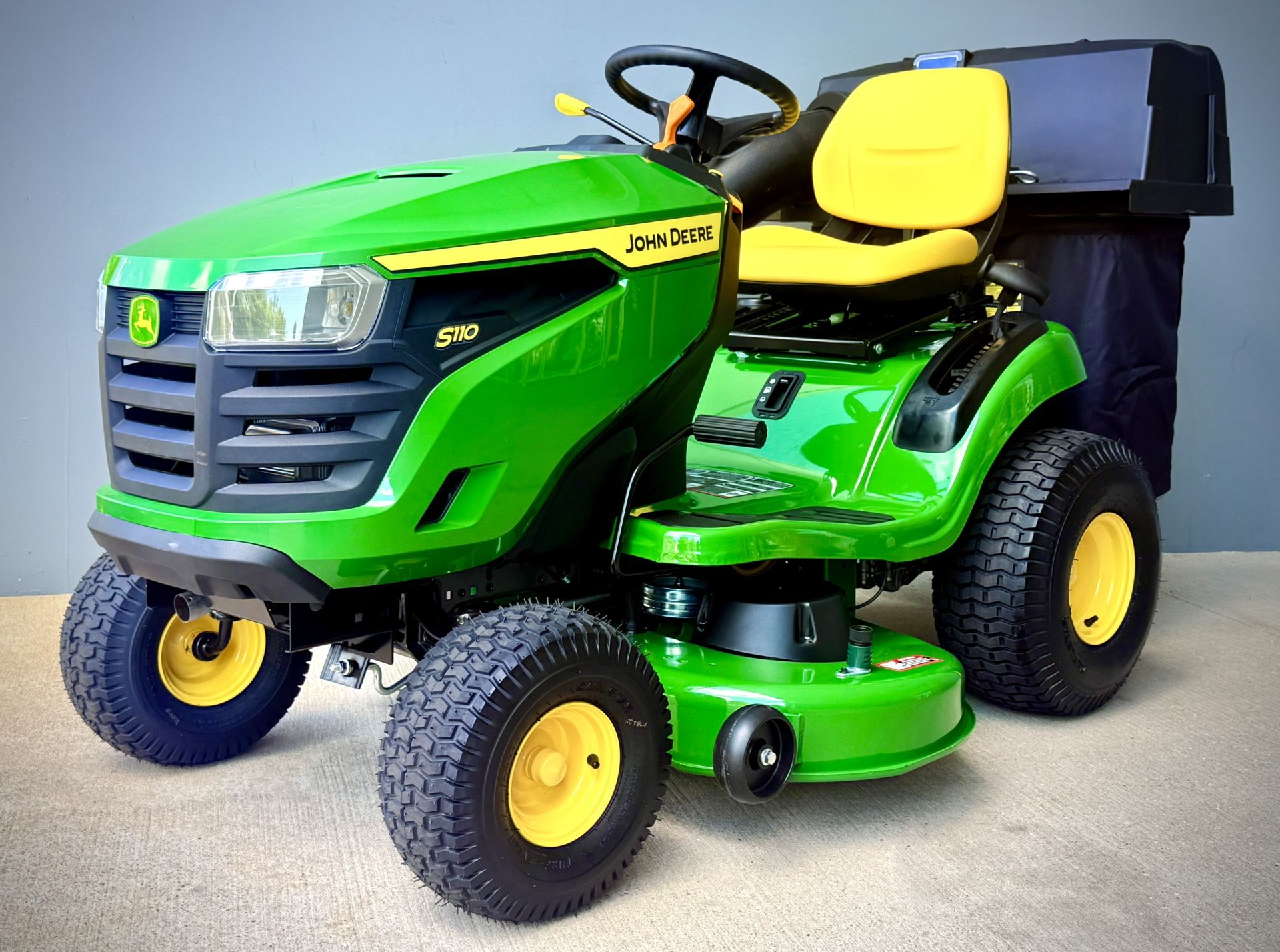 Brand new John Deere S110 42-in 19 - HP Gas Riding lawn mower comes with John Deere Bagger.