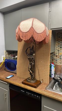 Figural female lamp with fringed shade