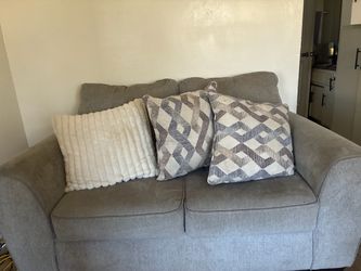 Grey couches, loveseat, and three seater