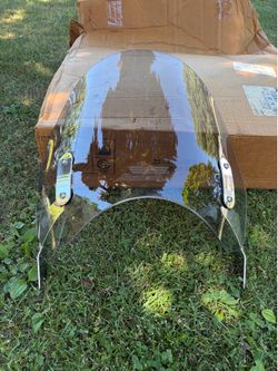 National cycle N21115 clear polycarbonate shield- NOS- item has a light smoke tint.