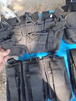 Pistol hostlers and magazine pockets for chest carrier