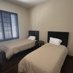Two twin sized bed frames + mattresses 