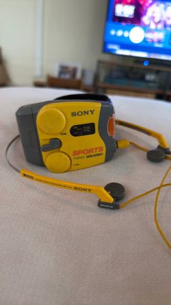 vintage yellow Sony Sports AM/FM radio with the Velcro/belt attachment