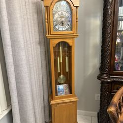 Vintage Traditional Grandfather clock in light wood finish.
