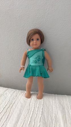 American girl doll ice skater wearing ice-skating dress with tights and bracelet
