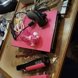 Nintendo wii system with pink top accents 
2 controllers 2 nunchucks all cords working perfectly