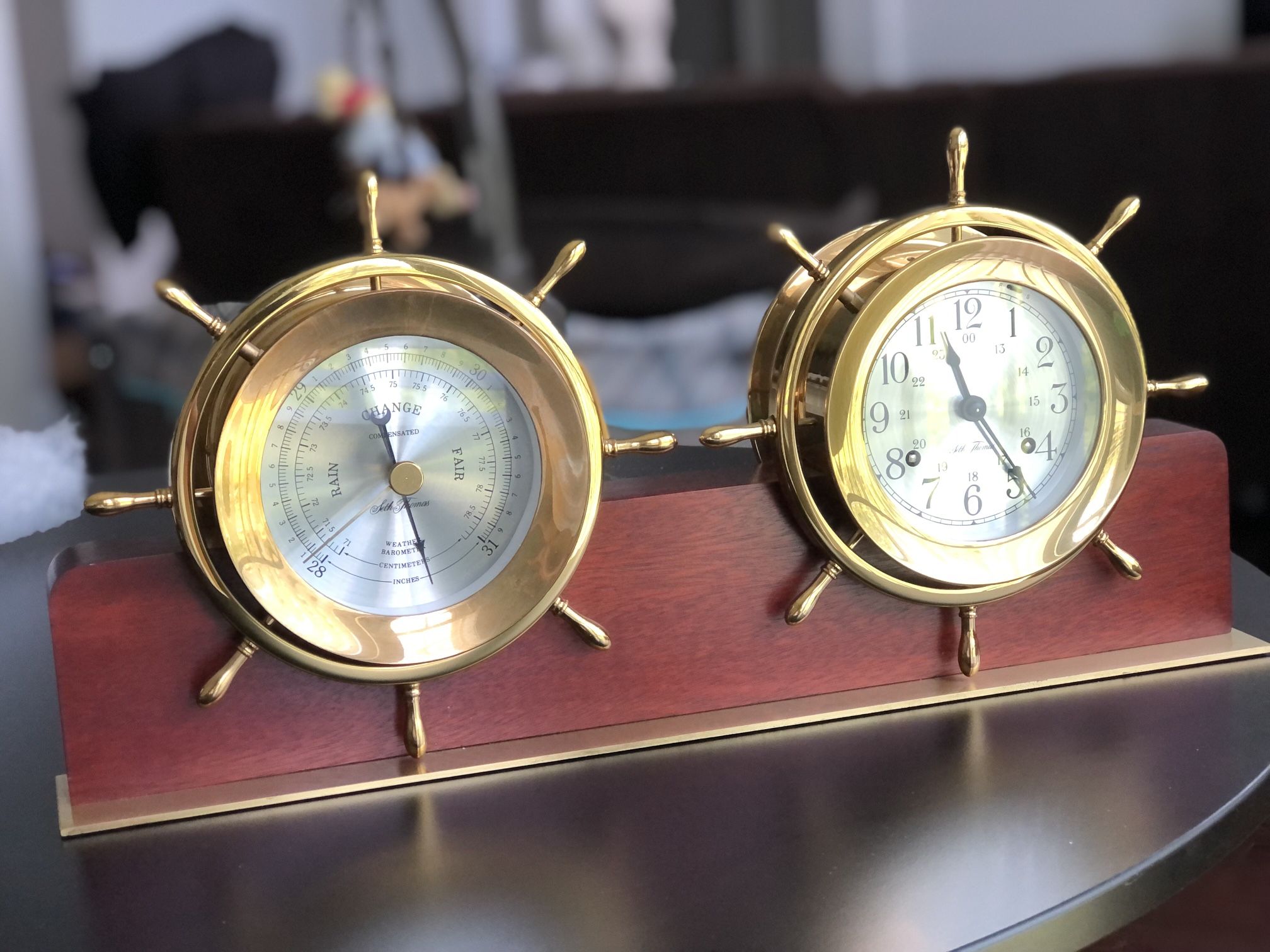 AMERICAN BRASS 'HELMSMAN' SHIP'S WHEEL CLOCK AND BAROMETER, SETH THOMAS CLOCK CO., THOMASTON, CONNECTICUT.