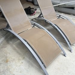 two pool lounge chairs 