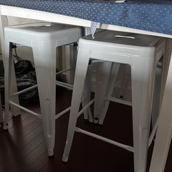 4 white metal barstools