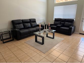 Black leather recliners with coffee table and end tables