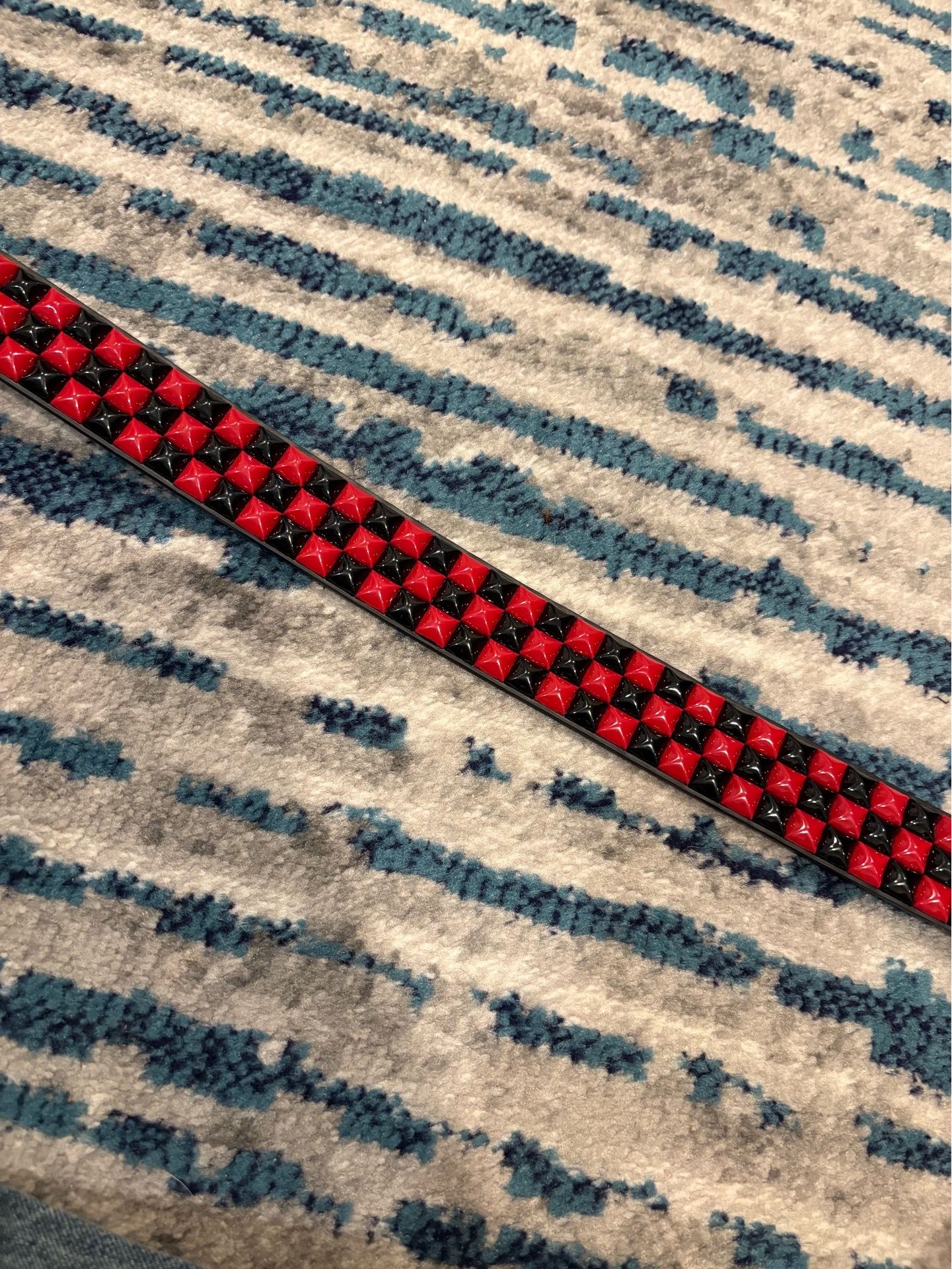 Black and red studded belt