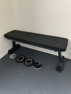 Flat workout bench with weight plates