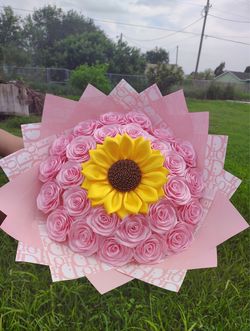 Bouquet of pink flowers with a sunflower in the middle
