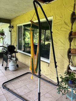 Adjustable heavy-duty hammock chair stand with a vibrant, multi-colored rope macrame hanging chair