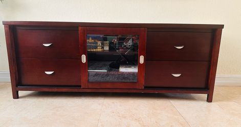 Russet Brown TV console features a central glass door for media storage.