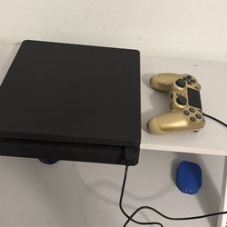 PS4 with controller and games.