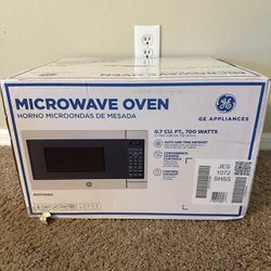 New GE - 0.7 Cu. Ft. Compact Microwave - Stainless Steel