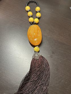 Pixiu natural amber pendant, paired with a yellow and black beaded necklace. Material: Pixiu carved