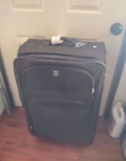 Large travel luggage with wheel delsey brand good shape.