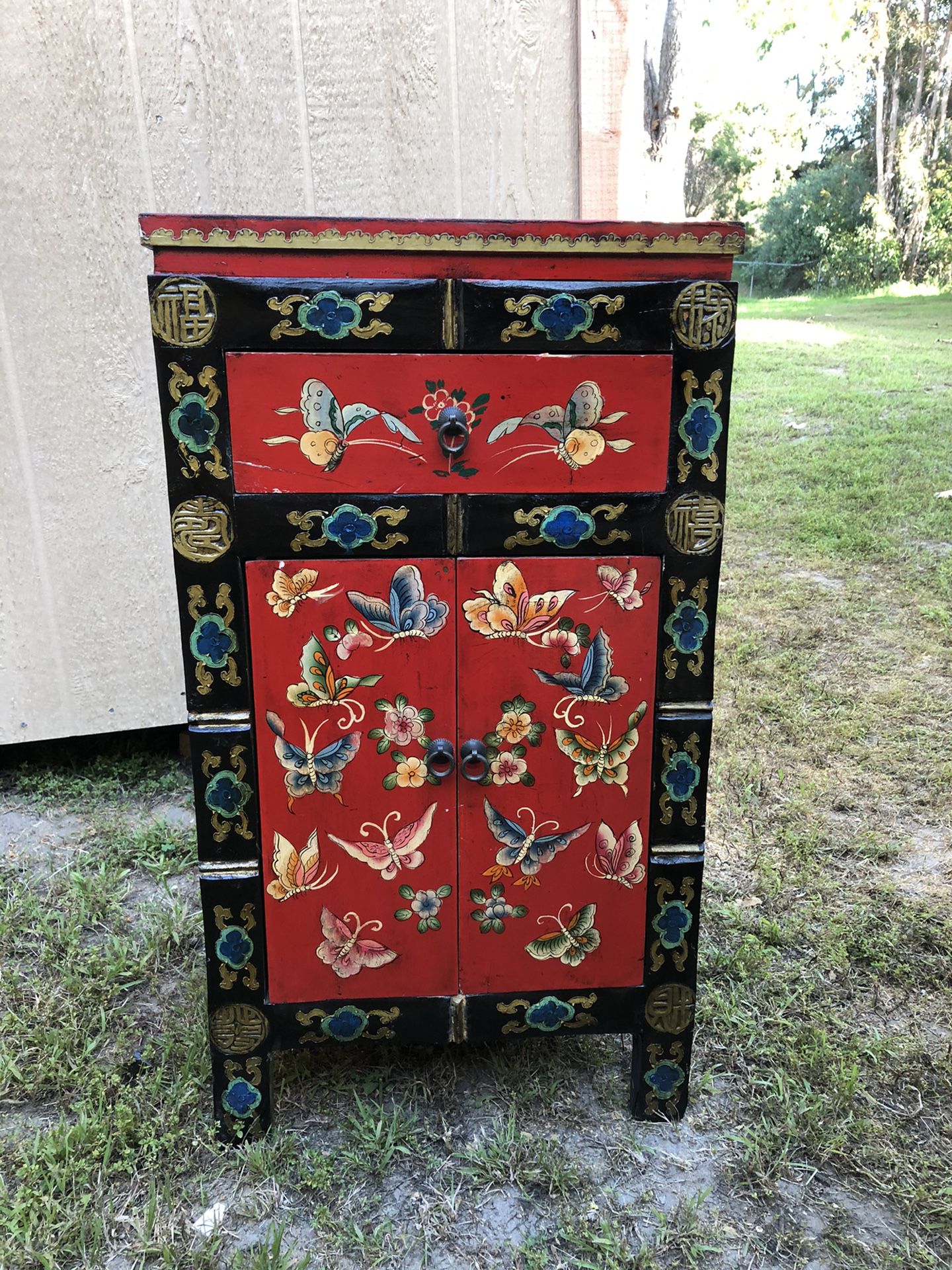 Hand painted red Asian art cabinet.