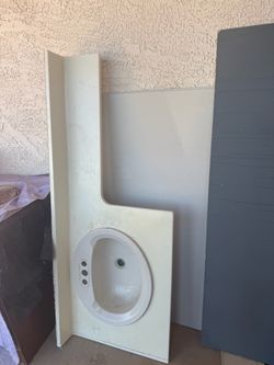 Sink, drywall, nice shelf for hanging clothes in garage