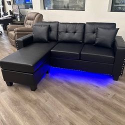 Black faux leather sectional sofa with LED