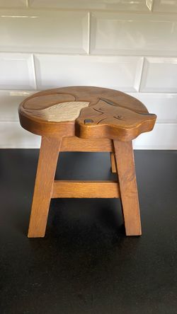 hand-carved acacia hardwood stool features a whimsical sleeping fox design