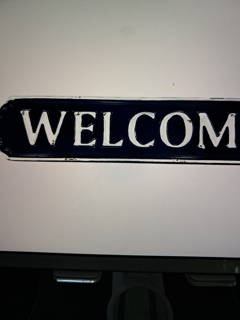  blue and white enamel welcome sign