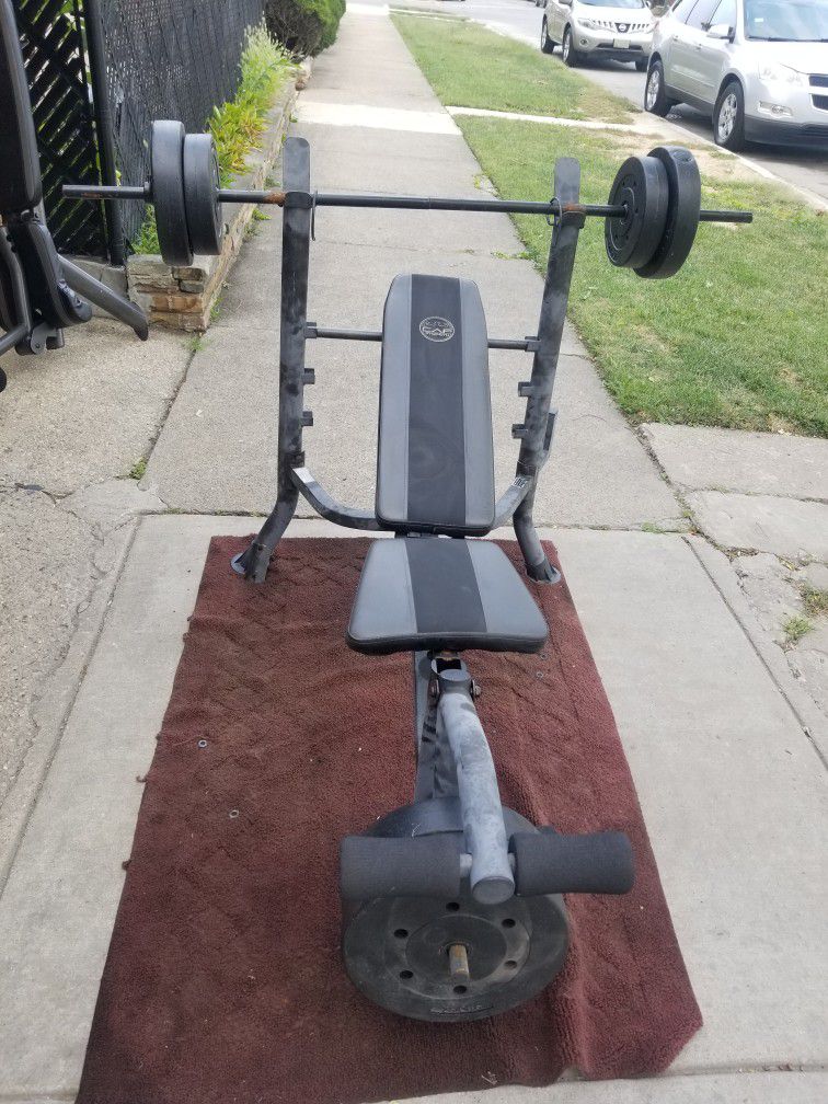 USED WEIGHT BENCH AND PLASTIC WEIGHTS 