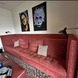 Large red wall length sofa perfect for a theatre room