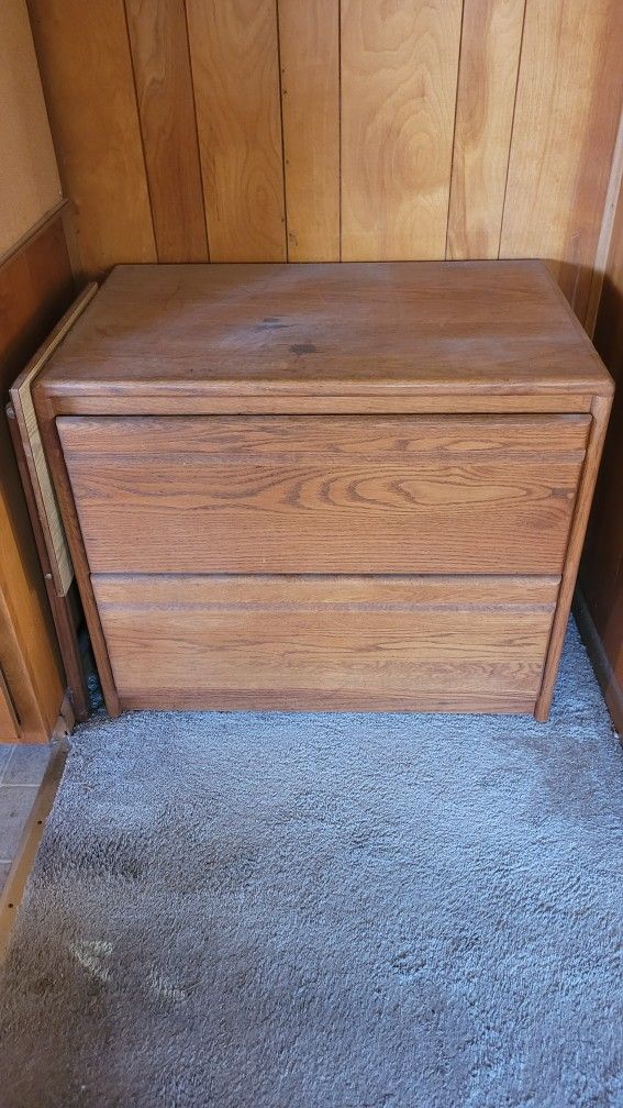 Two drawer wood file cabinet.