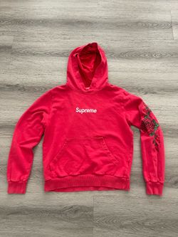 Red supreme hoodie has a couple of rips