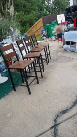Four Wood  barstools with metal base. Good condition. Very Sturdy