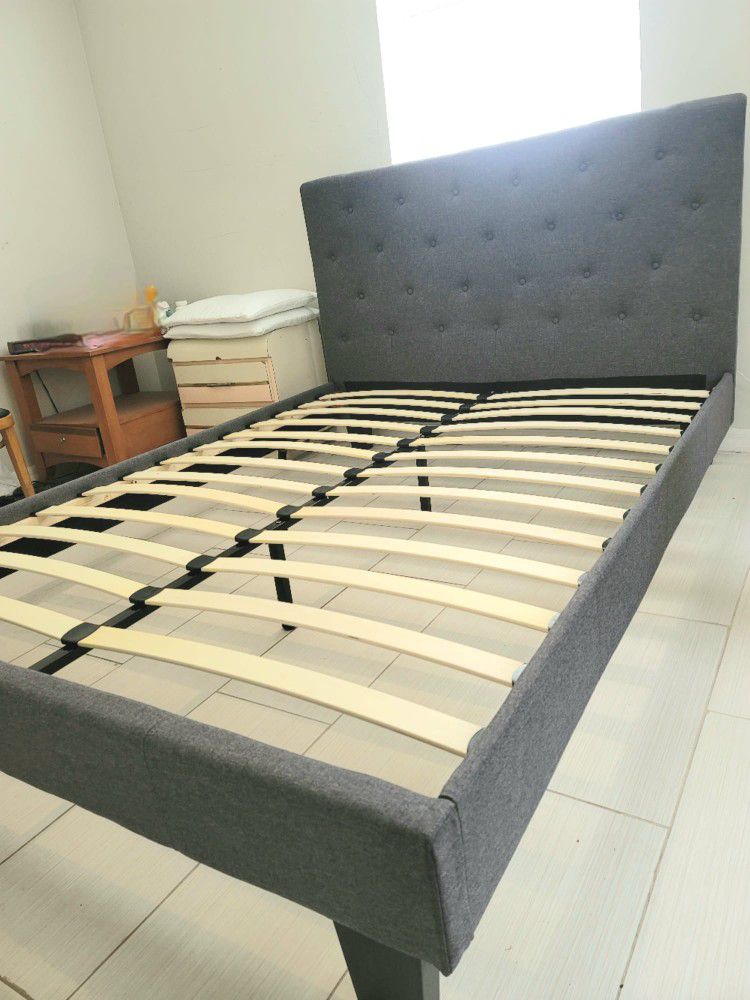NEW QUEEN UPHOLSTERED BED FRAME. Mattress sold separately
