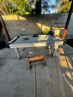Pool table with cue holder