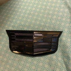 Cadillac front grille or rear liftgate emblem. 