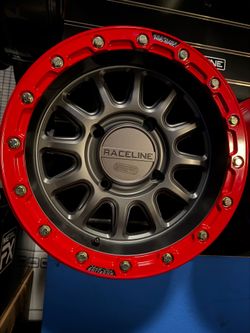 On sale.  BF Goodrich km3 tires 32x10-15 & RACELINE  15x7 4x137 Beadlock  Grey/Red Wheels (We Finance)