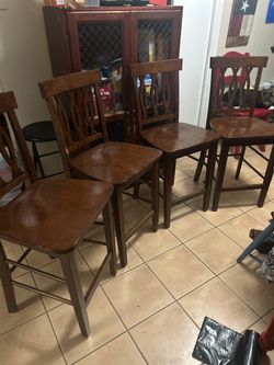 Four Dark Wooden Counter -Height Bar Stools
