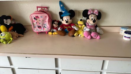 Disney plushes and rolling Minnie suitcase