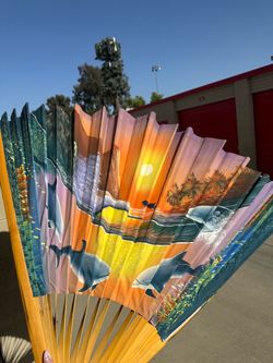 Large decorative folding fan – sunset dolphin design. Perfect for wall decor, photos, or summer events.