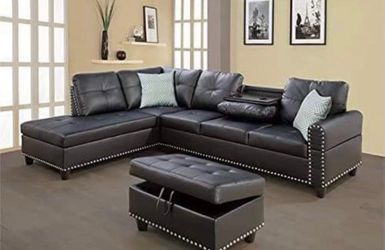 Black leather sectional couch with drop down table