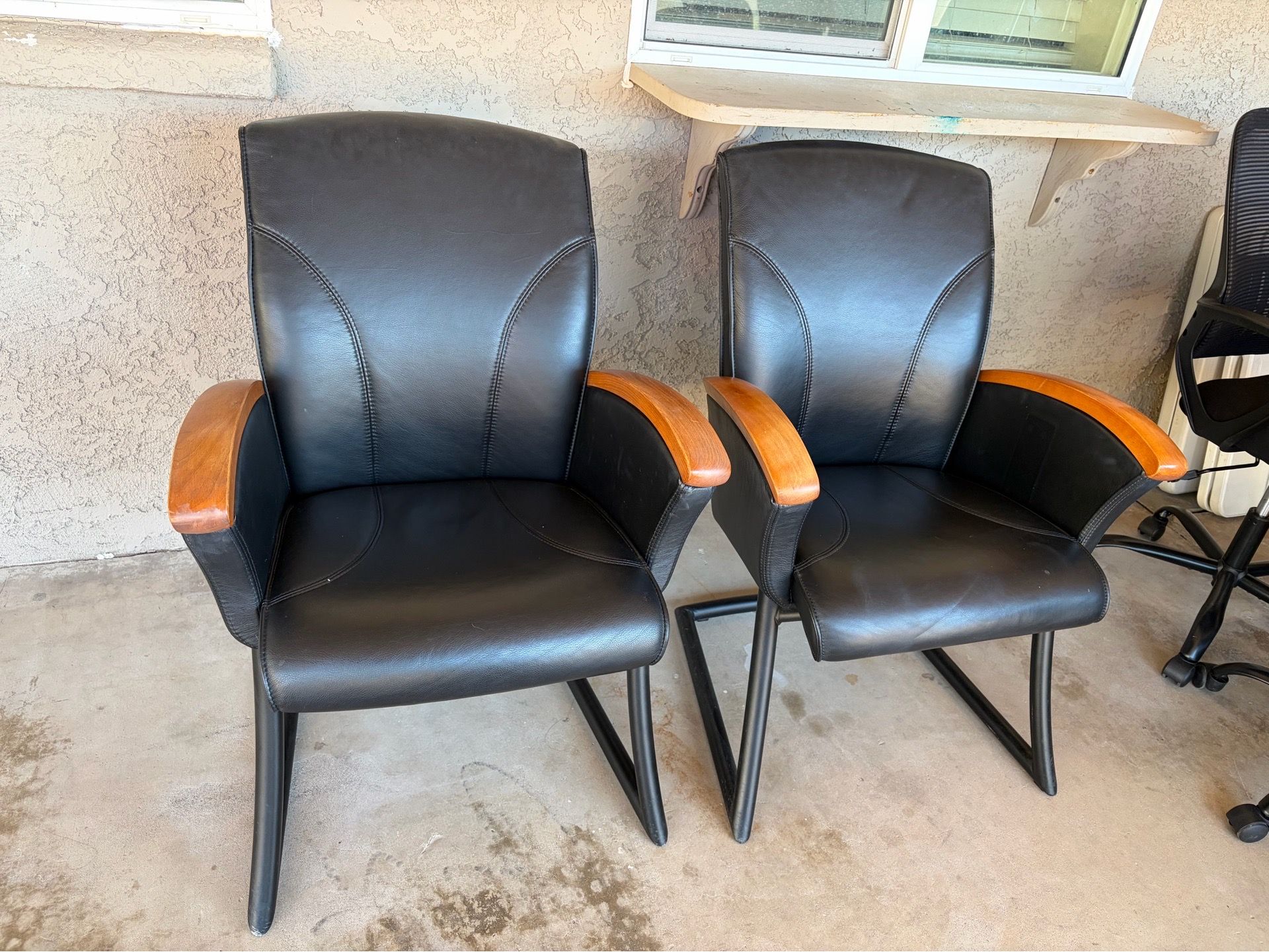 2 black leather office chairs