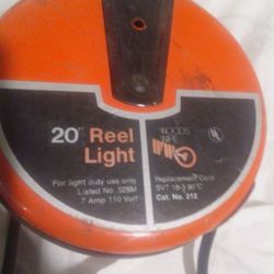 Woods Wire Retractable Reel Light, which is a 20-foot extension cord with a built-in reel and a light.

