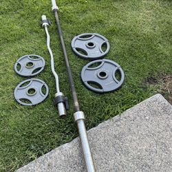 Olympic weights 2x35, 2x10 lbs with curling bar and 7 ft 45 lb barbell