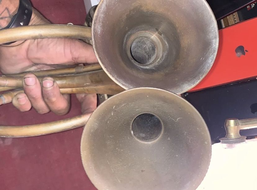 Antique made with brass and copper soldered together trumpets made in India