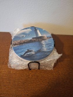 Dolphin with lighthouse coasters
