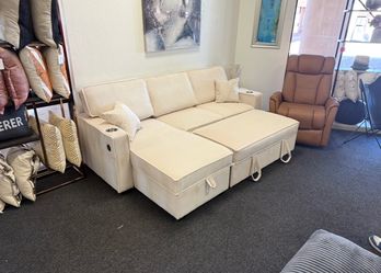 Ivory sleeper sofa with reversible storage chaise