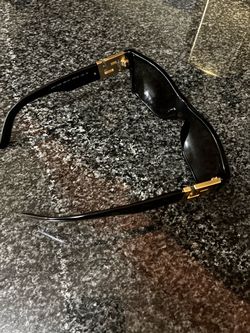 Versace Black Sunglasses with Gold Hardware and a Carti pen
