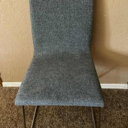 Modern gray upholstered chair with metal legs